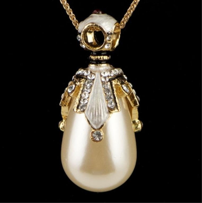 Faux Pearl Faberge Inspired Pendant: Faux Pearl Faberge Inspired Pendant Elegant and grandiose, this Faberge inspired egg pendant is ready to add the extra something to complete the look of an outfit! Features: 1.5" (H) x 0.5" (D) 68
