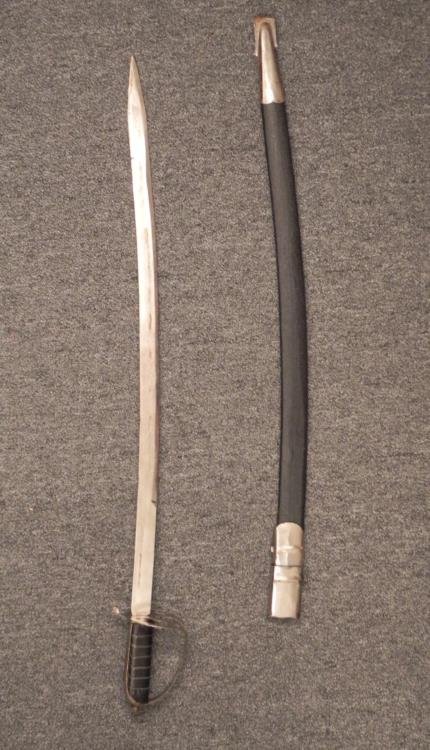 Indian Vintage Sword w/Engraved Blade, Scabbard: This an older Indian sword with engraved blade and scabbard. The grip has leatherette and wire wrap. The blade is marked Made In India, and has a decorative pattern. There is some in/out wear and mark