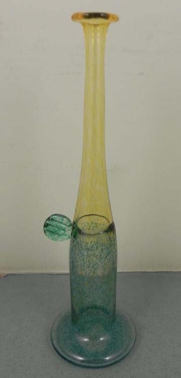 Kosta Boda Art Glass Vase Artist Signed B. Vallin: This Kosta Boda glass vase has a pale blue base, with green stylized stem near the middle, and a pale yellow neck and rim. Underneath the base it is etched with the Kosta name, and the name of the art