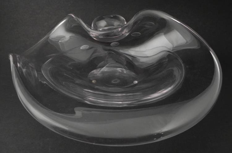 Large Clear Free form Art Glass Bowl: This bowl is clear glass with bubbles around one end, a large rounded portion, and flowing rim. It appearrs natural, like a large clear seashell in a deep ocean. * * * Medium: Blown glass * Dimensions