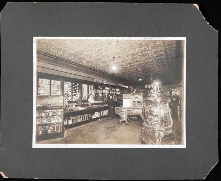 Antique Albumen Photograph General Store w/Stoves: This antique albumen is an interior portrait of a general store and its owners. Shown are three employees behind the counter, and one person posing as a customer. A large expanse can be seen, includin