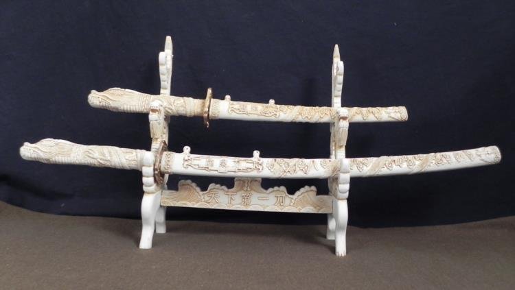 JAPANESE SAMURAI SWORDS-WAKAZASHI & TONTO W/ DRAGONS: JAPANESE SAMURAI SWORDS-WAKAZASHI & TONTO W/STAND-ORNATE DRAGONS * * OUTSTANDINGLY BEAUTIFUL JAPANESE TYPE SAMURAI SWORDS WITH MATCHING DISPLAY STAND--BOTH SWORDS AND STAND ARE A FAUX AGED IVORY--