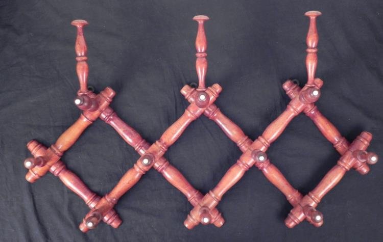 Antique Walnut Accordion Wall Rack Hat Hanger: This is an accordion style wall rack dating from the early 20th century. It is walnut, with all the porcelain buttons still present on the ends. The upper three hangers have tall adjustable knobs for 