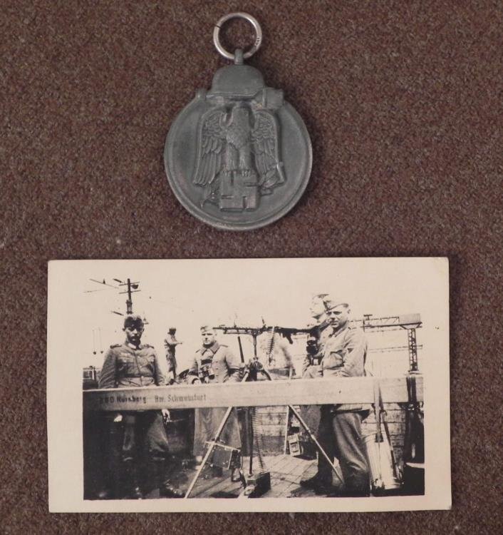 NAZI RUSSIAN FRONT MEDAL & PIC NAZI SECURITY NURENBURG: NAZI RUSSIAN FRONT MEDAL & PIC OF NAZI SECURITY AT NURENBURG W/MACHINE GUN2 NICE ORIGINAL PERIOD ITEMS-MEDAL HAS HELMET & GRENADE ON TOP-EAGLE & SWASTIKA CENTER-REVERSE "WINTERSCHLACT IM O