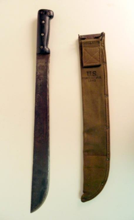 1945 US Military Machete w/ Canvas Cover: Offered here is this 1945 US Military Machete. It comes with a canvas cover, which reads "U.S.- (unreadable) - 1945". The knife is 23" long and the blade is 17". It seems there were some numbers and w
