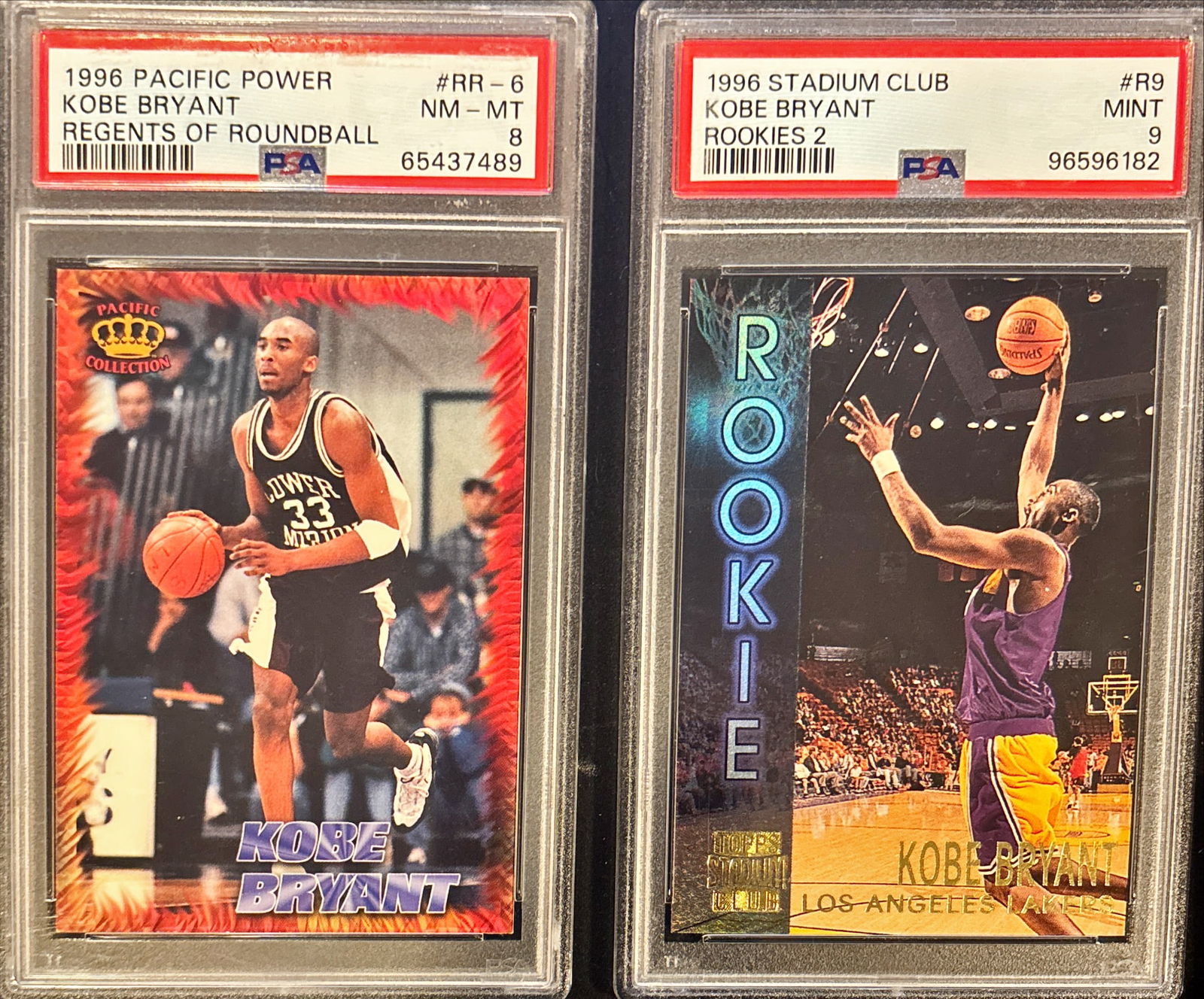 Lot of 2 Kobe Bryant Rookie-Era Cards – PSA 8 & PSA 9: This lot includes two graded Kobe Bryant cards:• 1996 Pacific Power “Regents of Roundball” #RR-6 – PSA 8 (NM-MT)• 1996 Stadium Club “Rookies 2” #R9 – PSA 9 (MINT)A strong