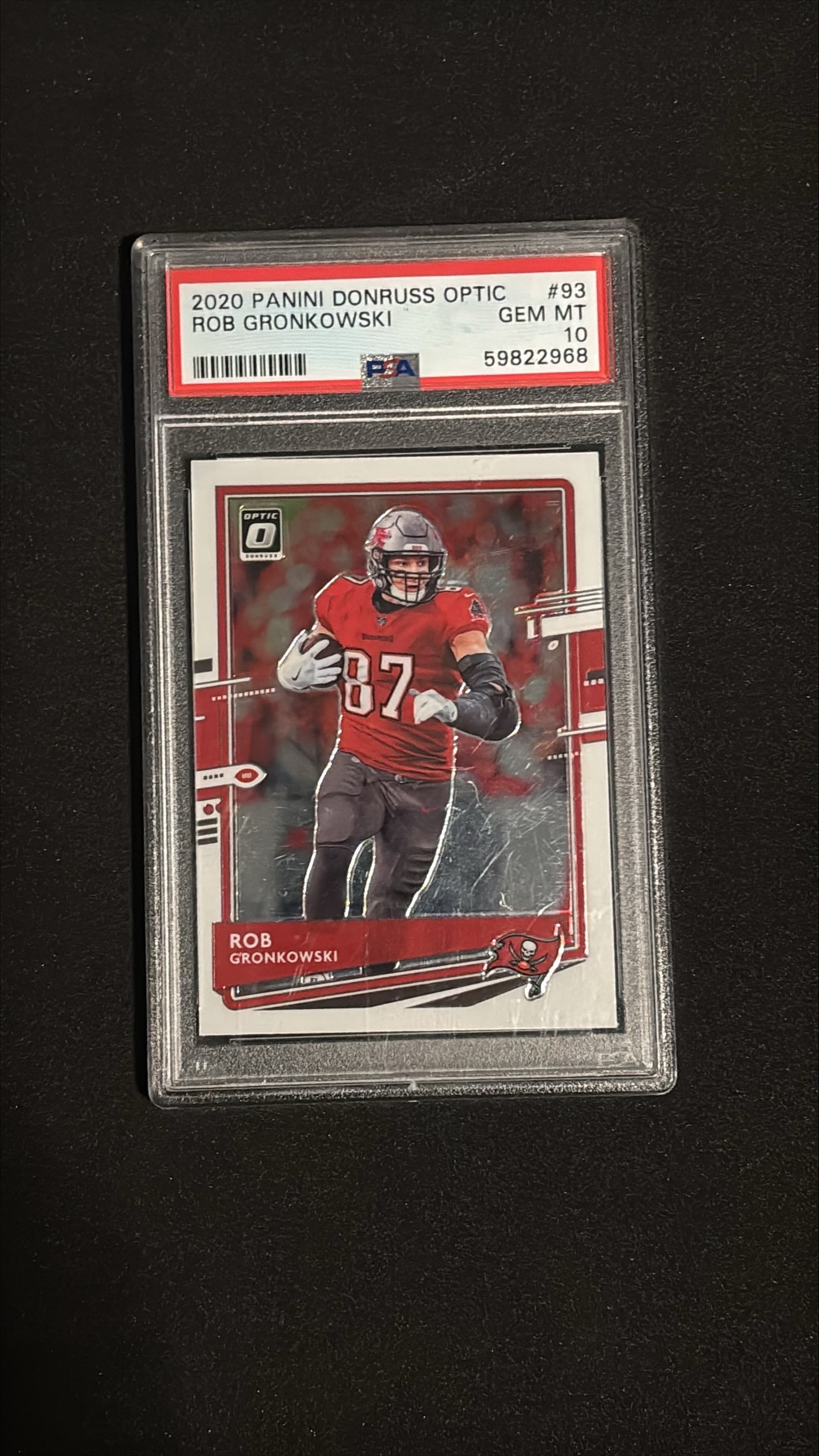 2020 Panini Donruss Optic #93 Rob Gronkowski PSA 10 GEM MINT: 2020 Panini Donruss Optic #93 Rob Gronkowski Tampa Bay Buccaneers. Graded PSA 10 GEM MINT. A pristine example of Gronkowski's inaugural Buccaneers card from his legendary 2020 debut season with Tampa 