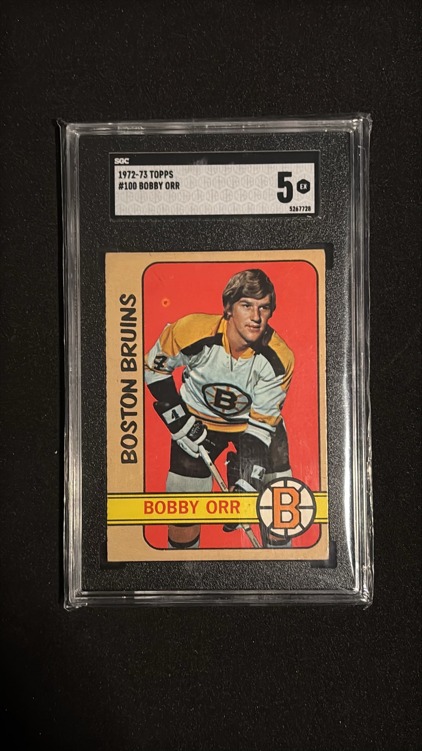 1972-73 Topps #100 Bobby Orr SGC 5 EX: 1972-73 Topps #100 Bobby Orr Boston Bruins Defenseman. Graded SGC 5 (Excellent). One of the greatest hockey players of all time and widely considered the greatest defenseman ever. Orr was a 9-time All