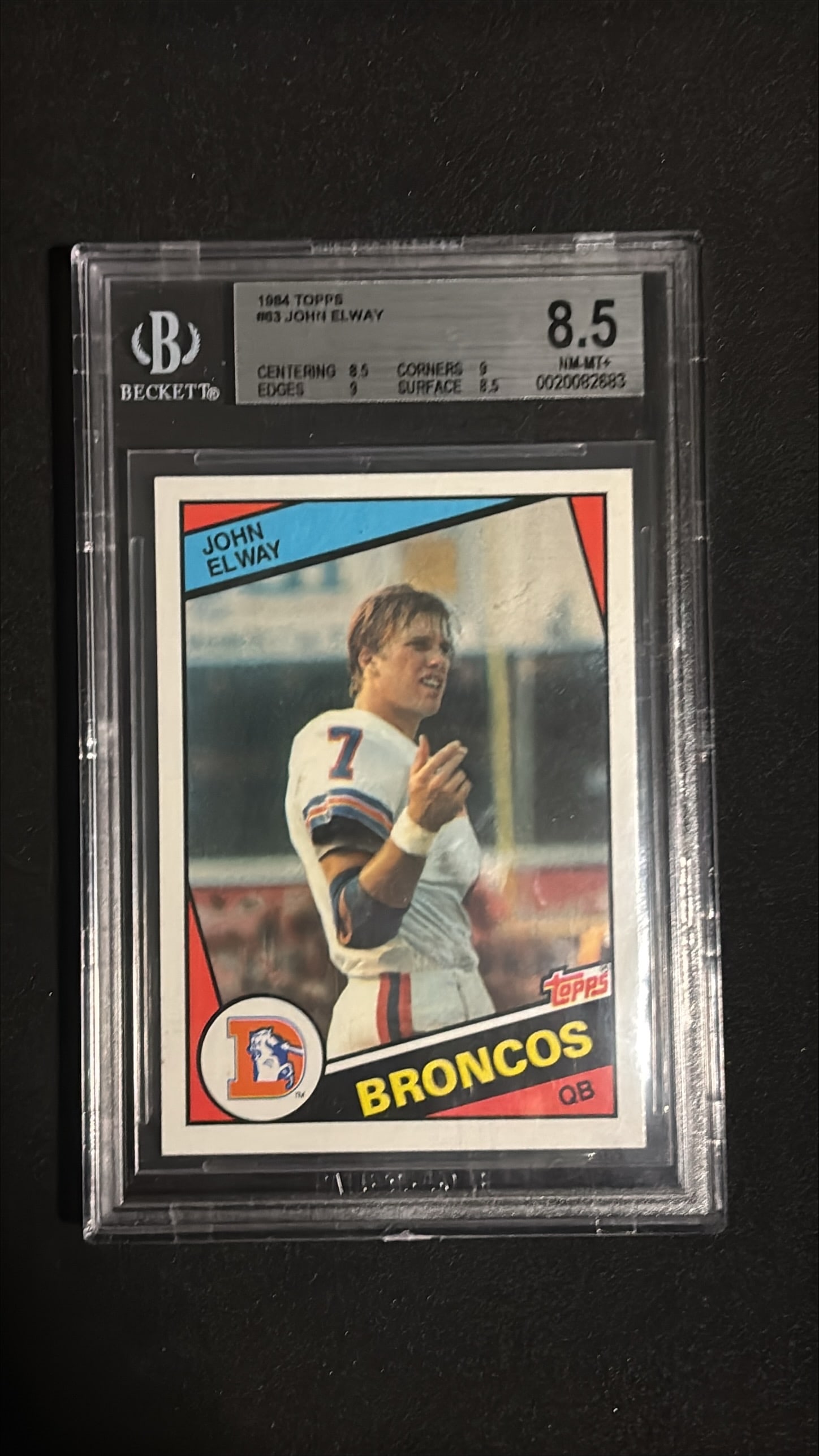 1984 Topps #63 John Elway BGS 8.5: 1984 Topps #63 John Elway graded BGS 8.5 (NM-MT+ - Near Mint to Mint Plus). Denver Broncos quarterback. John Elway is one of the greatest quarterbacks and most iconic players in NFL history. Hall of F