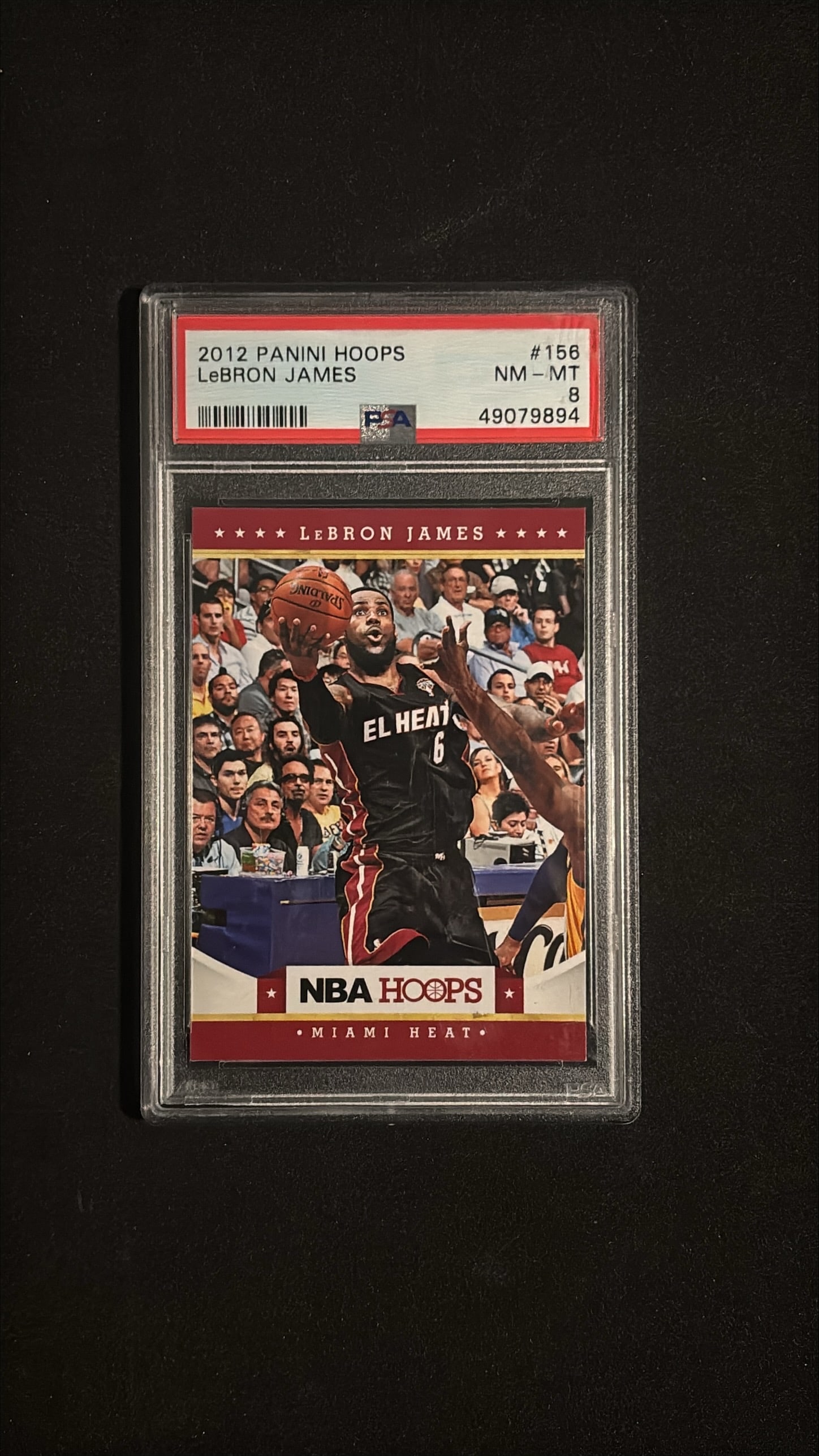 2012 Panini Hoops #156 LeBron James PSA 8 NM-MT - Miami Heat: 2012 Panini Hoops #156 LeBron James graded PSA 8 NM-MT. King James during Miami Heat era. HOF forward, 4x NBA champion, 4x MVP, 19x All-Star.