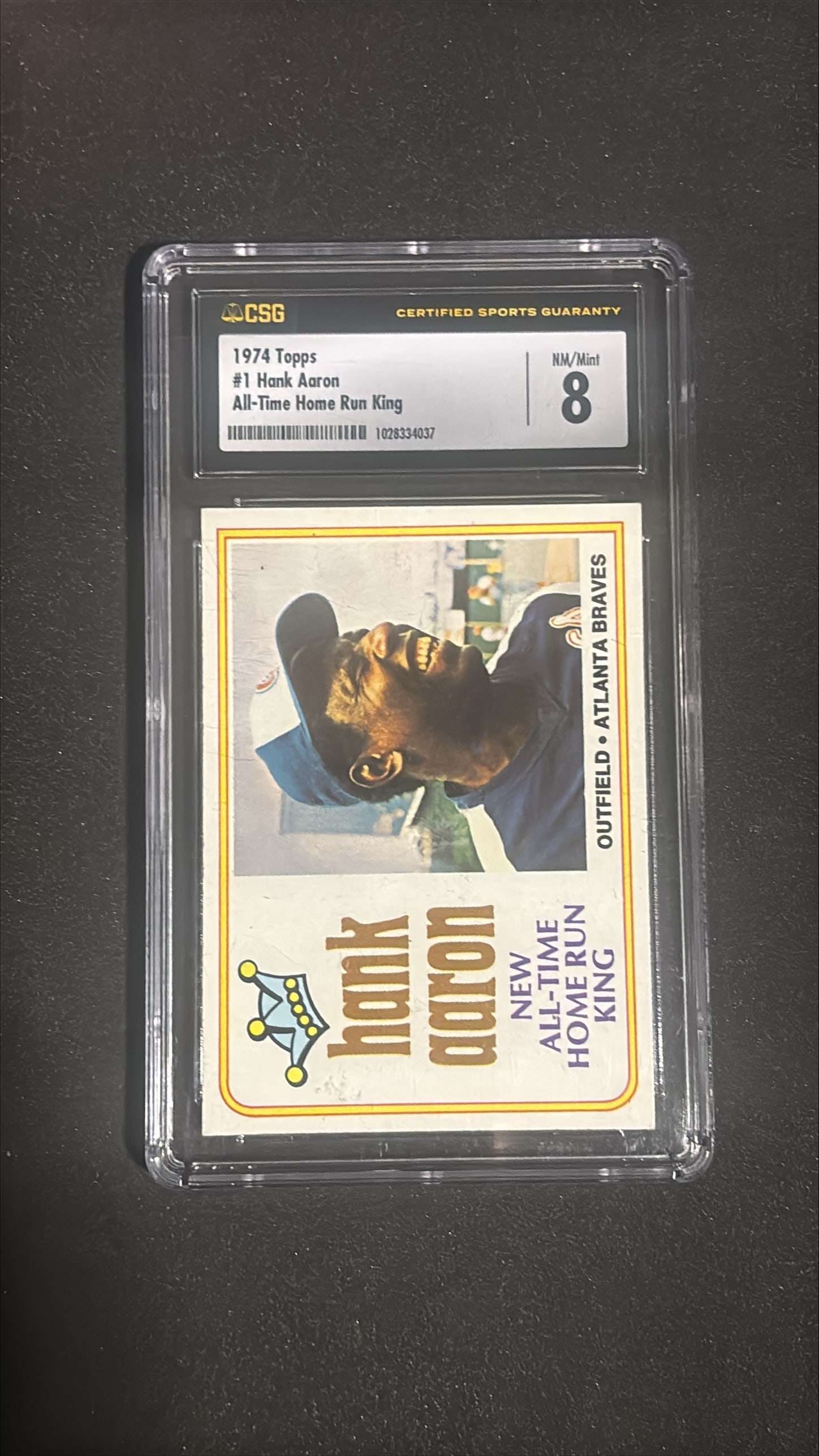 1974 Topps #1 Hank Aaron All Time HR King CSG 8: 1974 Topps #1 Hank Aaron "All Time Home Run King" graded CSG 8 (NM/Mint). Iconic card commemorating Aaron breaking Babe Ruth's all-time home run record on April 8, 1974. Hall of Famer. High-grade exam