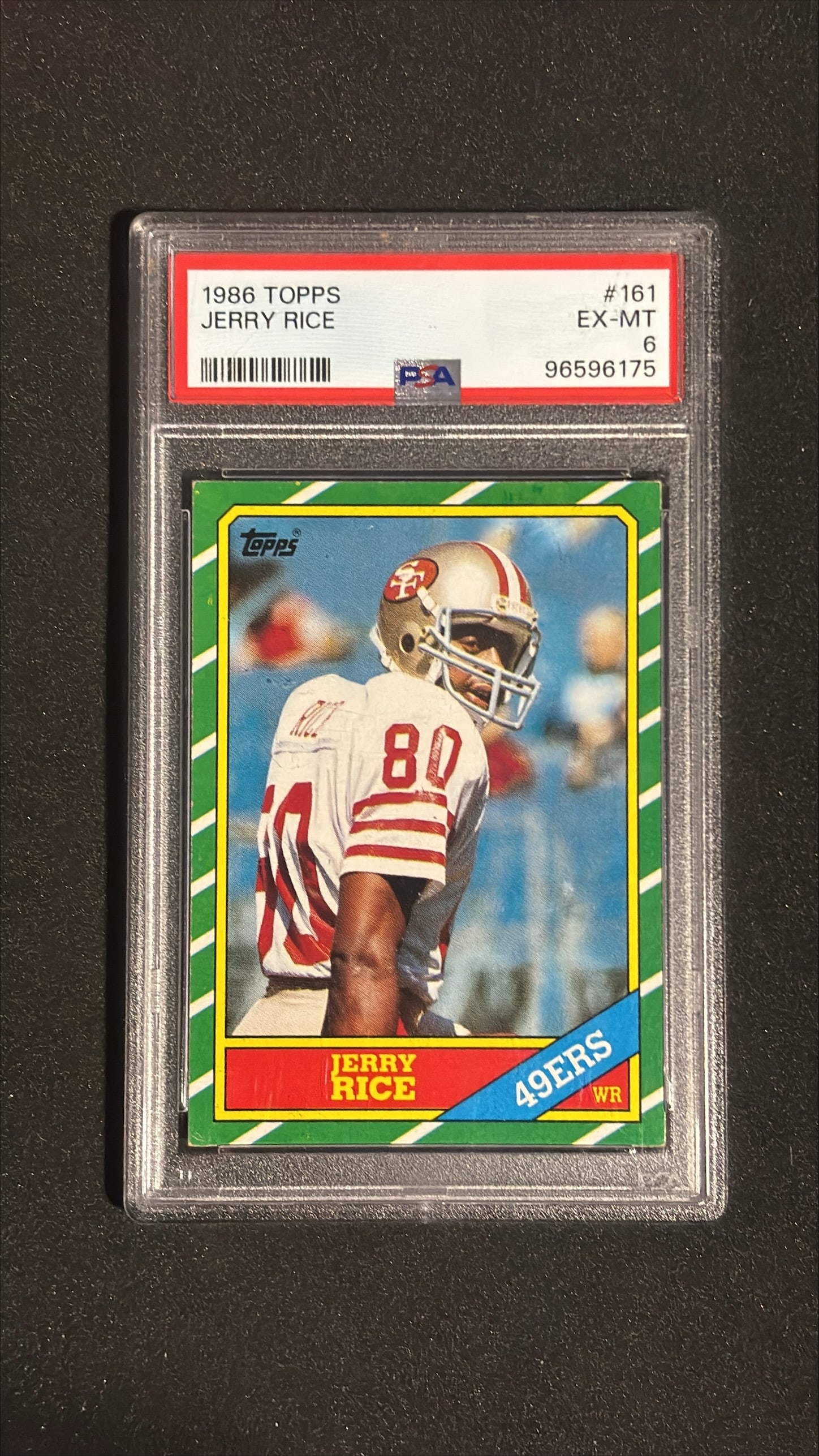 1986 Topps #161 Jerry Rice PSA 6 EX-MT: 1986 Topps #161 Jerry Rice graded PSA 6 (EX-MT). Iconic Hall of Fame rookie card. San Francisco 49ers receiver. One of the greatest football players of all time. Sharp vintage football card.