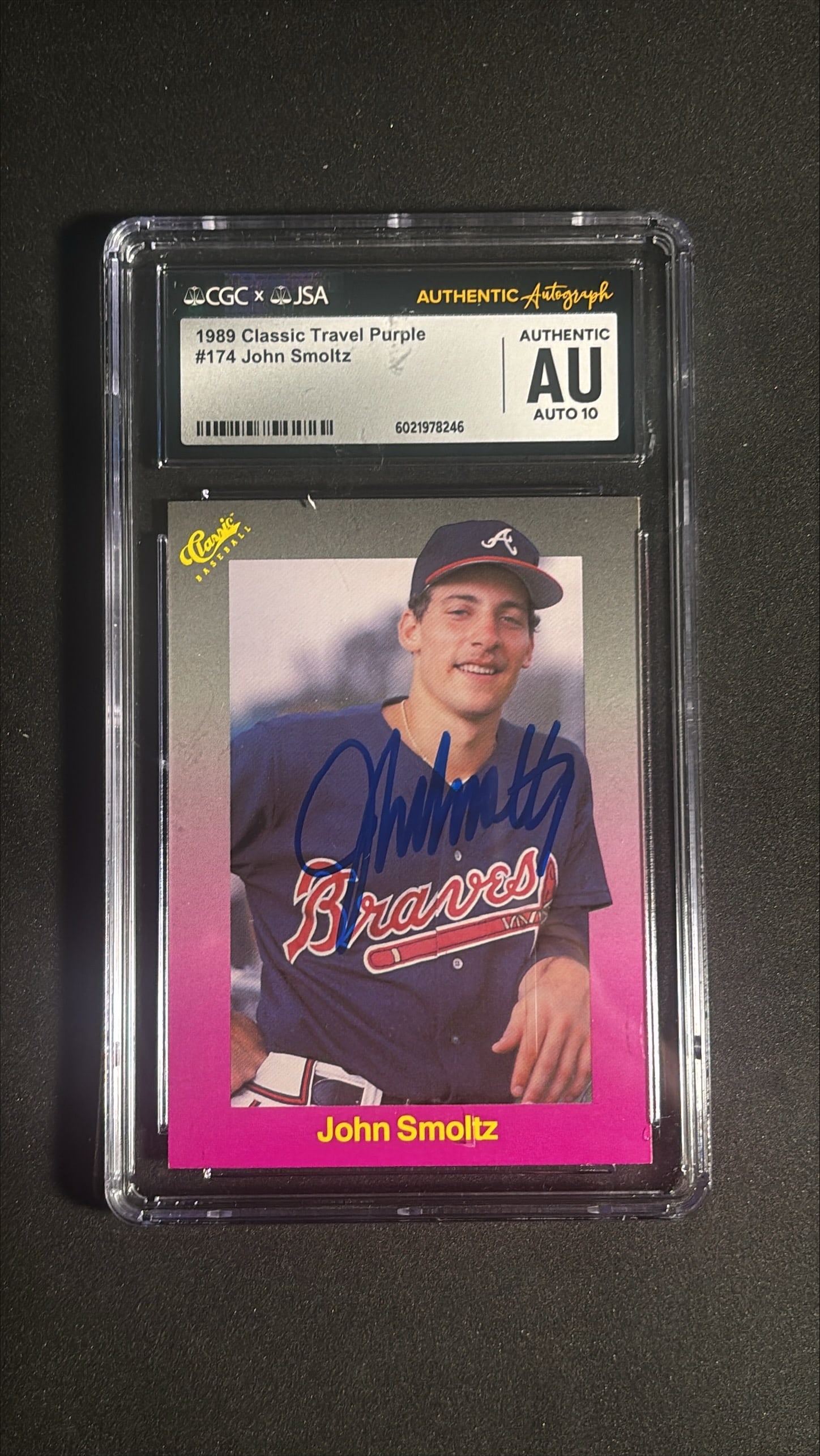 1989 Classic Travel Purple John Smoltz #174 CGC JSA Auto 10: 1989 Classic Travel Purple John Smoltz card number 174, encapsulated by CGC with the autograph authenticated by JSA, certification number 6021978246. The on card autograph is graded a perfect AU 10, b