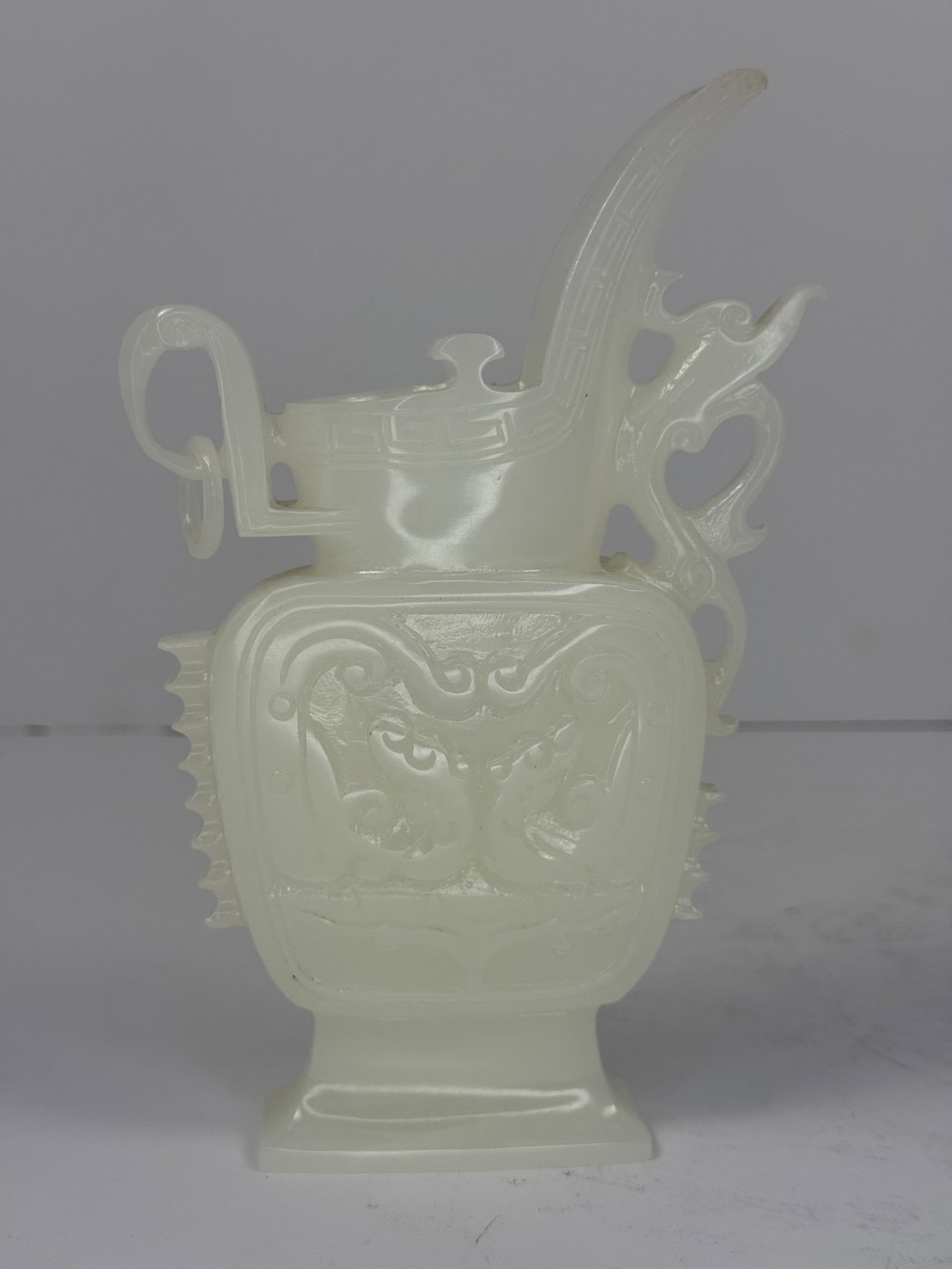 Chinese White Jade / Stone Archaistic Ritual Form Vessel: Elegant Chinese carved white jade / Stone archaistic ritual form vessel (though it is predominantly sculptural rather than intended as a functional container.) featuring stylized mask motifs, geometri