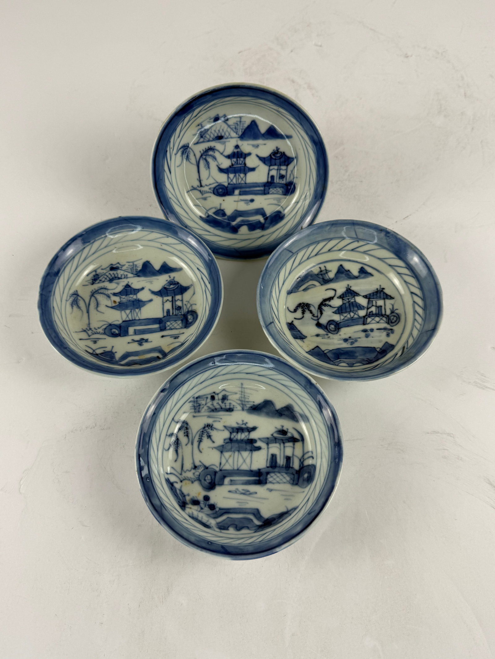 Set of 4 Chinese Canton Blue & White Porcelain Bowls, Pavilion Landscapes: A set of four Chinese Canton porcelain bowls, decorated in underglaze blue with traditional landscape scenes featuring pavilions, mountains, and waterside elements. Each bowl is hand-painted with slig
