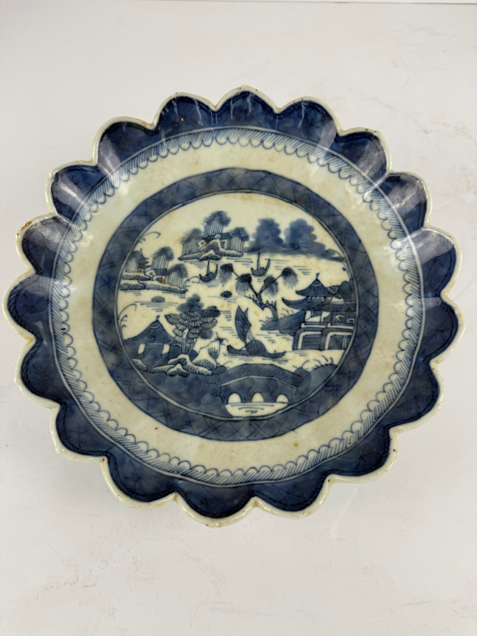Antique Chinese Canton Blue & White Porcelain Scalloped Flower Bowl: A beautifully formed antique Chinese Canton blue and white porcelain flower bowl, featuring a distinctive scalloped rim and finely rendered landscape decoration in rich cobalt tones. The interior is c