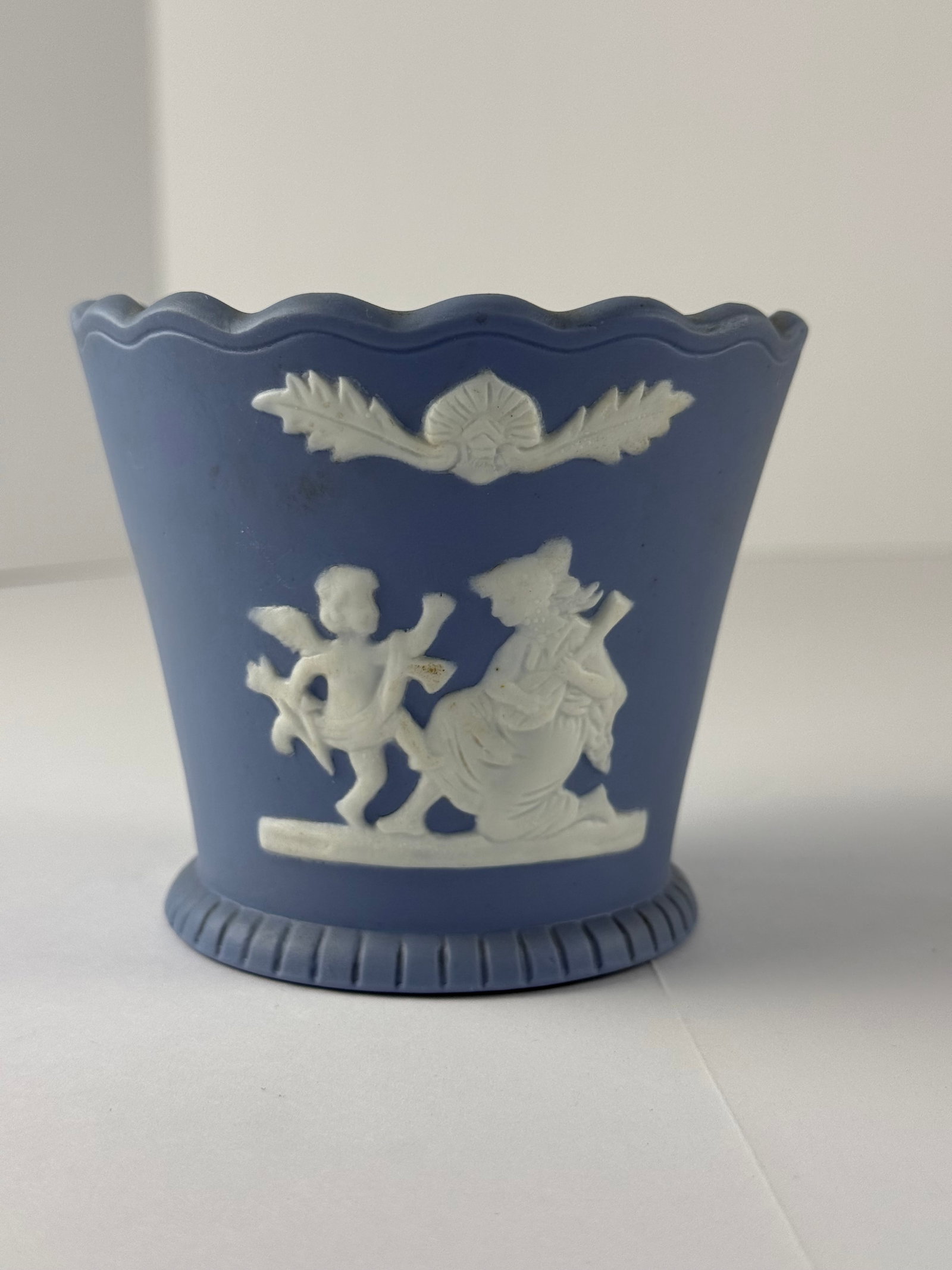 Blue Jasperware Style Cachepot Planter with Classical Relief, Wedgwood Inspired Decorative Vessel: A blue jasperware-style cachepot or decorative planter featuring applied white relief of a classical figural scene with cherub and robed figure. The piece is rendered in the traditional matte blue gro