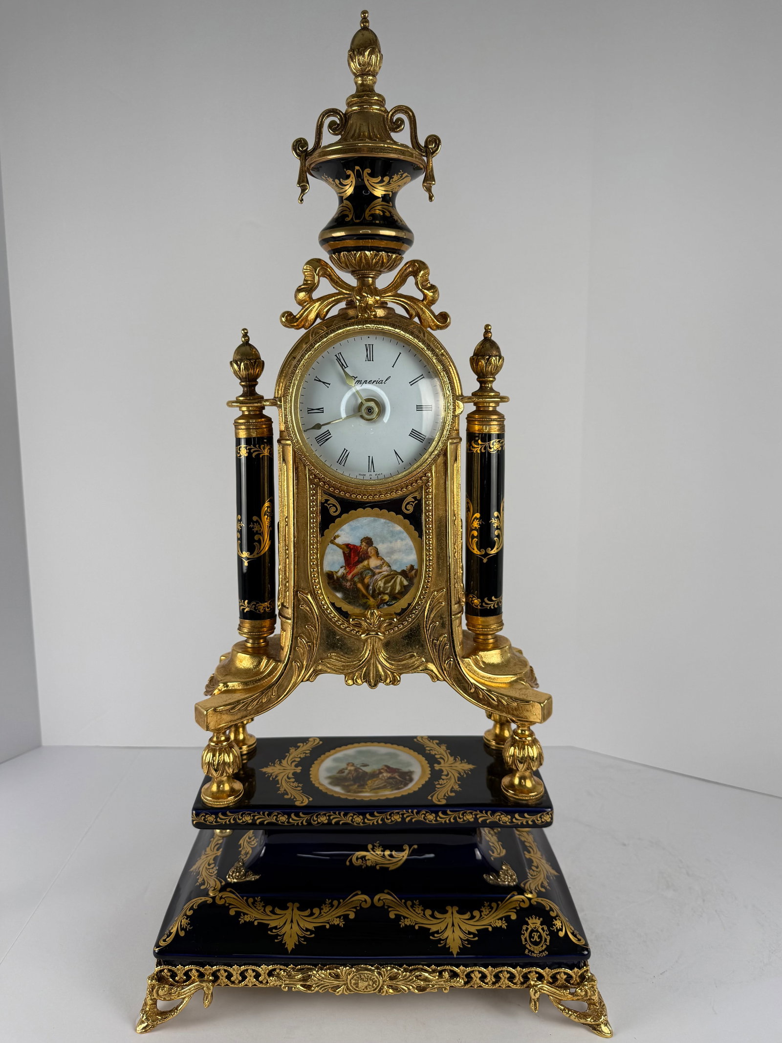 Imperial R. Limoges Cobalt Blue & Gilt Mantel Clock: A magnificent and highly decorative large-form mantel clock executed in an opulent French Revival taste, featuring an architectural gilt metal framework accented with deep cobalt blue porcelain-style 