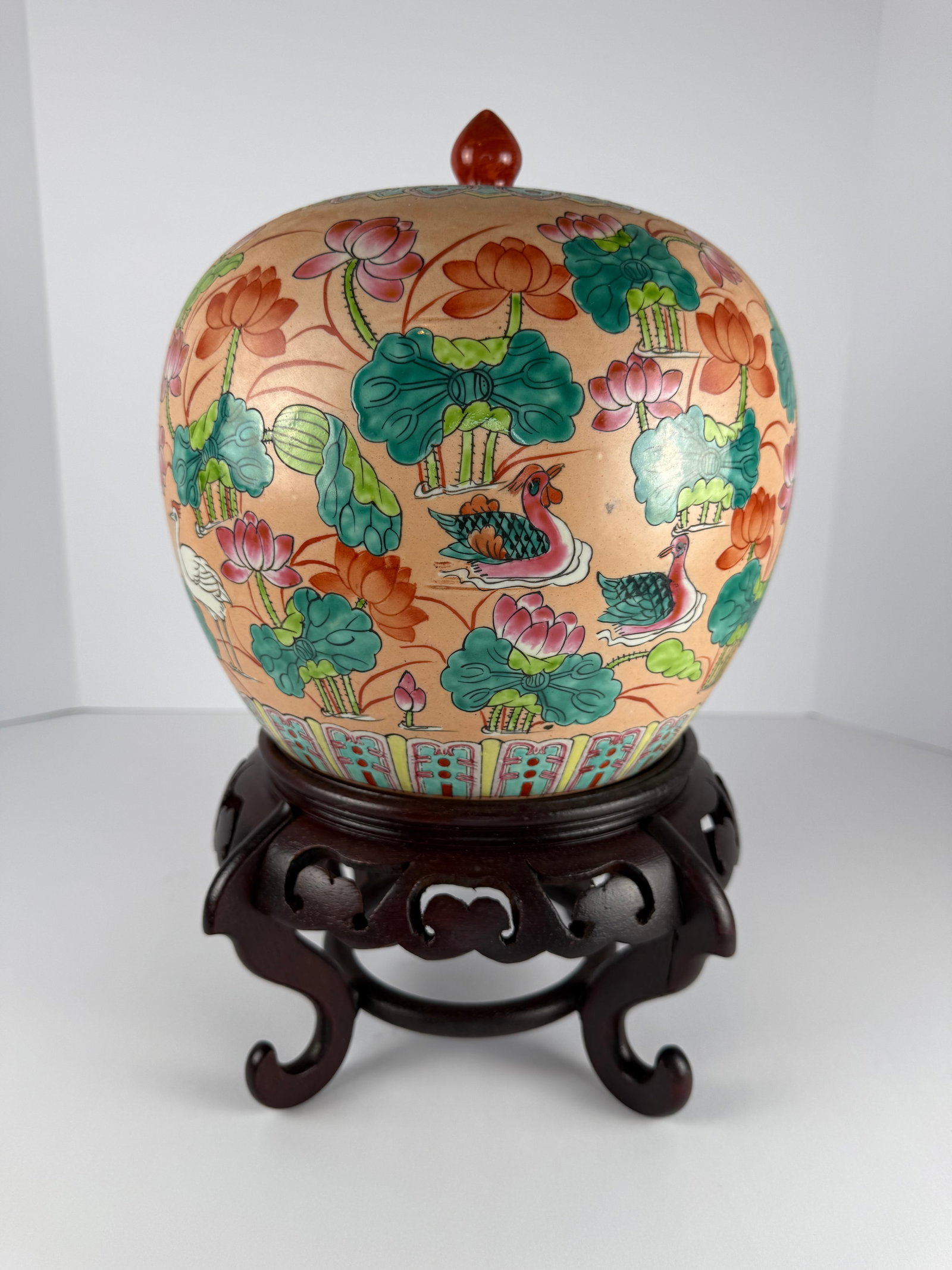Chinese Export Porcelain Lotus & Mandarin Duck Ginger Jar: Large Chinese porcelain ginger jar with fitted lid and carved wooden stand, finely decorated in famille rose style with lotus blossoms, lily pads, and mandarin duck motifs throughout. Retains its orig