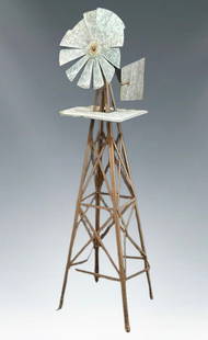 Authentic Vintage American Windmill Sculpture | Galvanized & Rusted Steel: Vintage Americana, this substantial windmill sculpture makes a dramatic statement. Standing over five feet tall, its classic form is immediately recognizable, bringing an architectural and kinetic ele