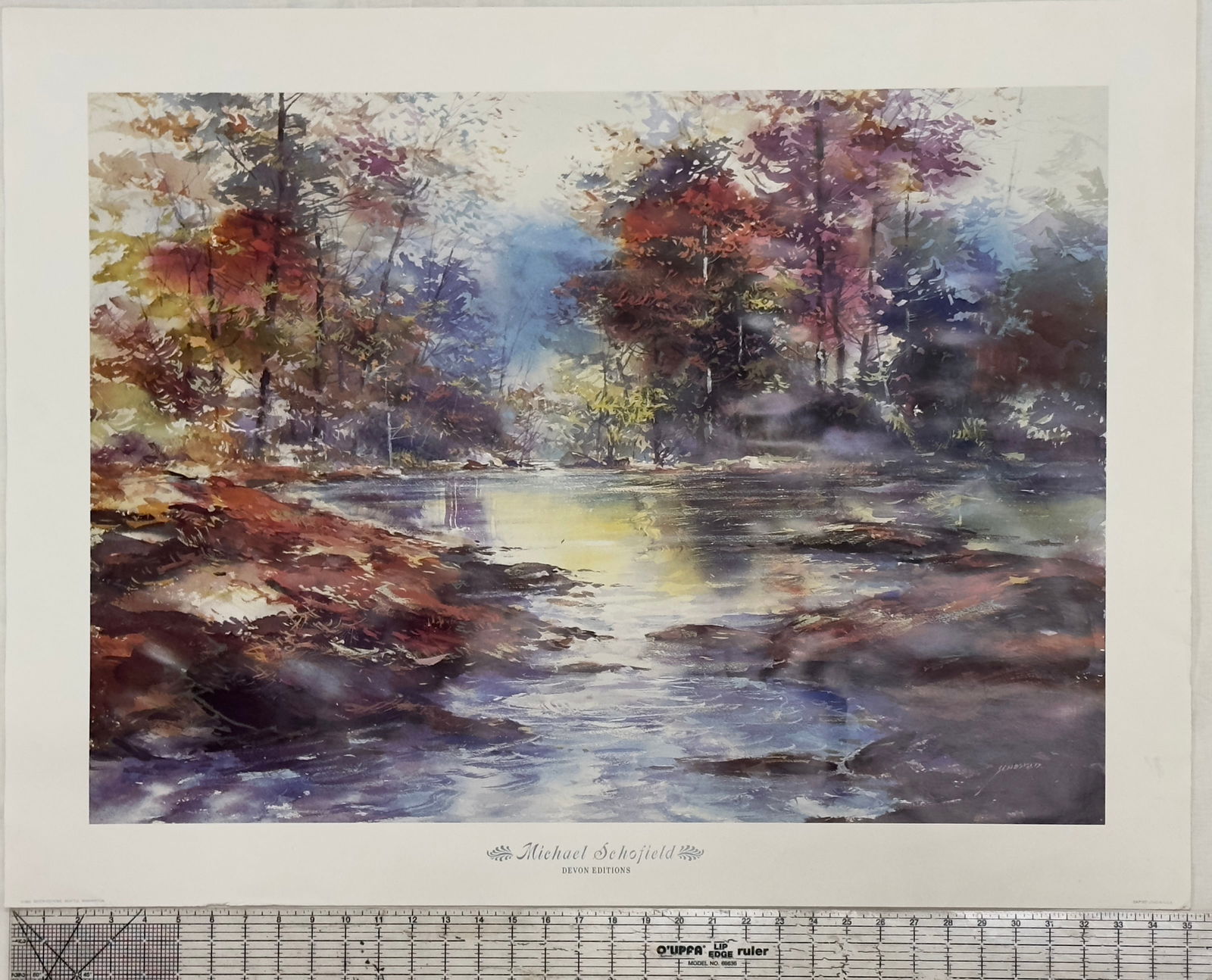 Michael Schofield Landscape Print, Devon Editions: A vibrant landscape print by Michael Schofield, showcasing a serene river scene surrounded by autumnal trees. The artwork captures the essence of nature with a blend of warm and cool tones, typical of