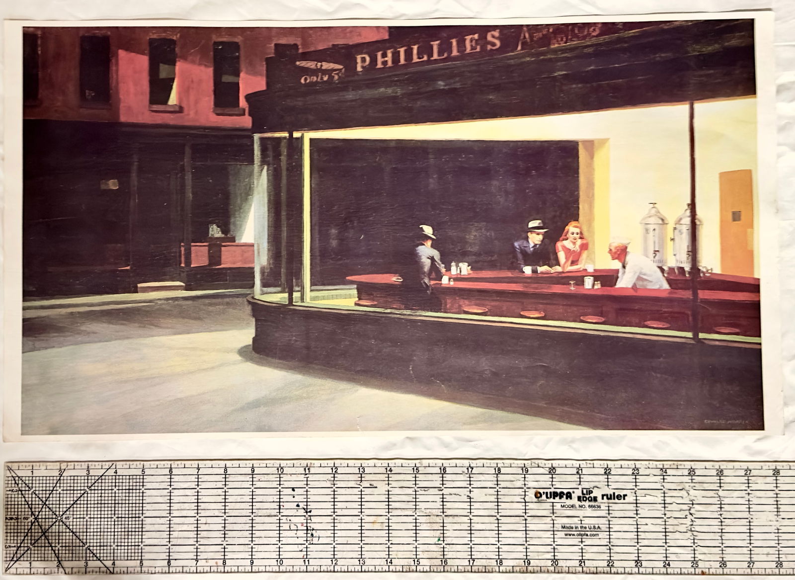 Vintage Print of Edward Hopper's 'Nighthawks': This is a vintage print reproduction of Edward Hopper's iconic painting 'Nighthawks'. The artwork depicts a late-night diner scene with four figures inside, characterized by its use of light and shado