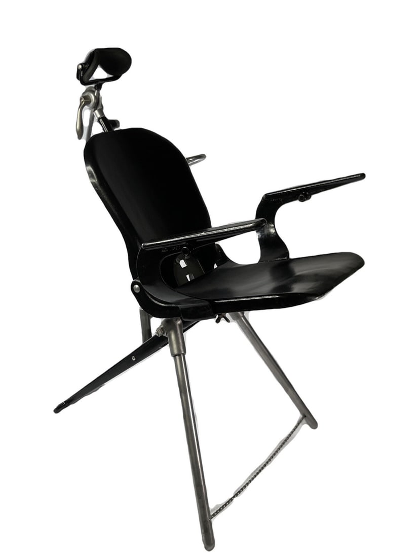 Vintage ALCOA Aluminum Dental Chair: This is a vintage dental chair manufactured by ALCOA, featuring a sleek black finish and aluminum construction. The chair showcases a mid-century modern design with adjustable headrest and armrests, i