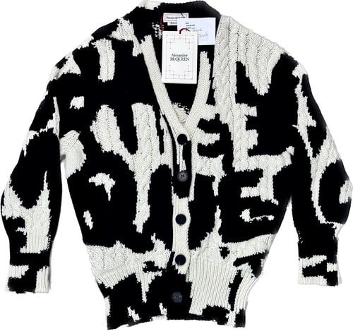 Alexander McQueen Black and White Knit Cardigan (M) NWT: This is a striking nwt Alexander McQueen cardigan featuring a bold black and white abstract pattern. The garment is crafted from high-quality knit fabric, showcasing intricate cable knit detailing. It