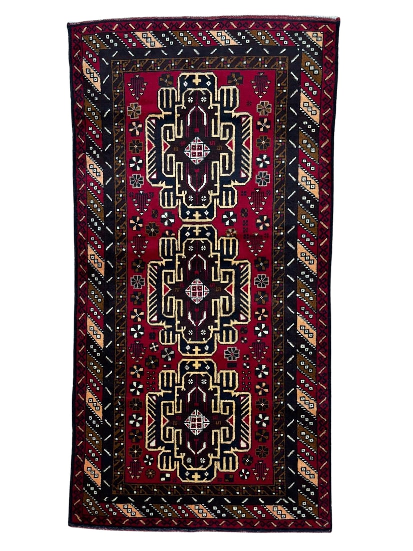 Vintage Beluch Wool Rug 3'6" x 7'0": Hand-knotted Beluch wool rug, measuring 3'6" x 7'0", with three geometric medallions on a deep red field with dark brown, ivory, and camel accents. Multiple geometric borders with tribal motifs throug