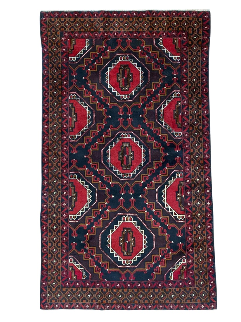 Vintage Beluch Wool Rug 3'5" x 6'3": Hand-knotted Beluch wool rug, measuring 3'5" x 6'3", with repeating geometric medallions on a dark indigo and deep red field with ivory and brown accents. Framed by multiple geometric borders with ang