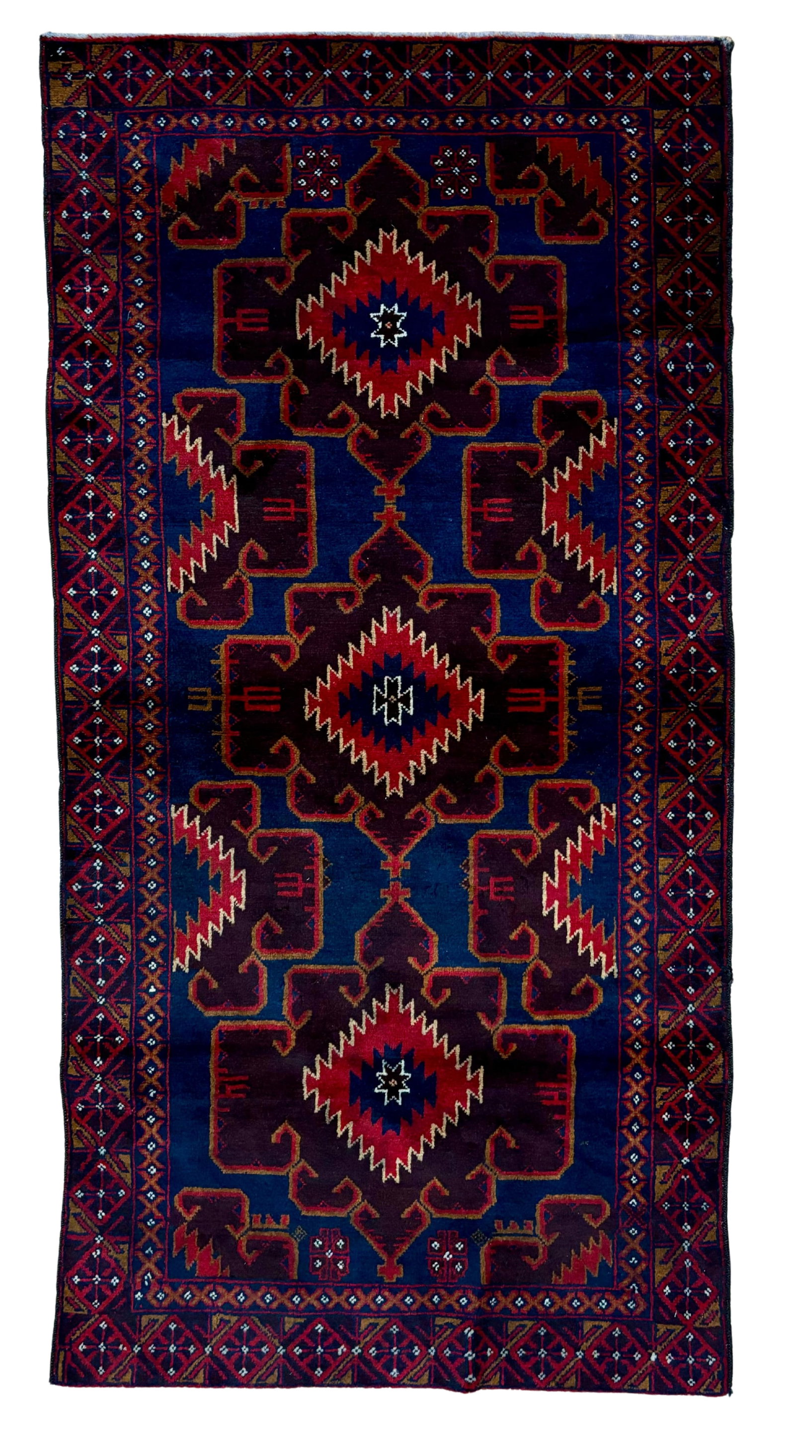 Vintage Baluch Wool Rug 3'8" x 5'5": Hand-knotted Baluch wool rug, measuring 3'8" x 5'5", with large geometric tribal medallions on a deep indigo field with burgundy, ivory, and red accents. Framed by multiple geometric borders with angu
