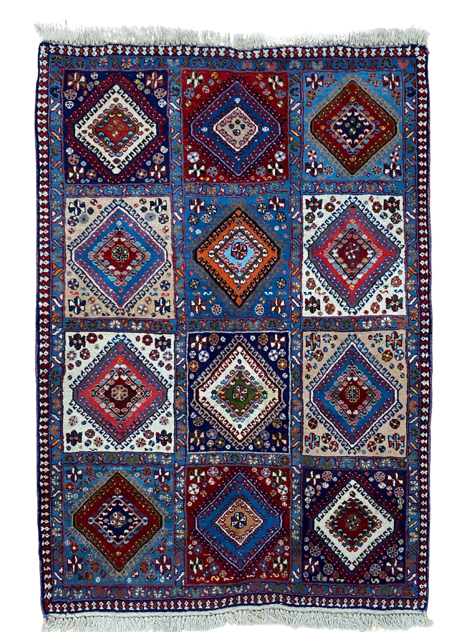 Vintage Persian Yalameh Rug 3'2" x 5'1": Hand-knotted Persian Yalameh rug, measuring 3'2" x 5'1", with a compartmentalized panel design featuring geometric diamond medallions in shades of sky blue, ivory, navy, red, and burgundy. Framed by m