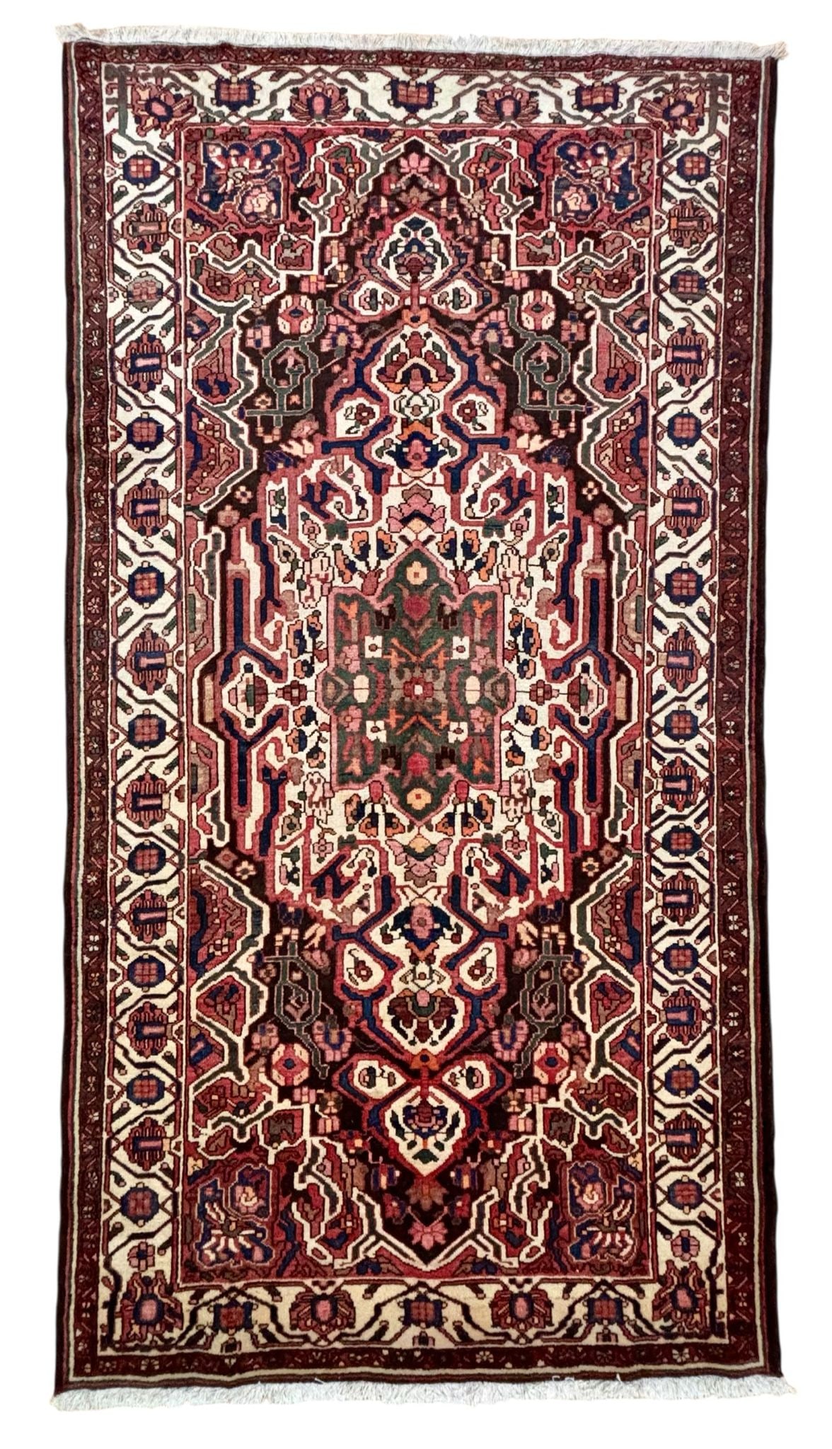 Vintage Persian Bakhtiari Wool Rug 5'3" x 10': Hand-knotted vintage Persian Bakhtiari wool rug featuring an allover geometric and floral pattern in ivory, brown, rust, green, and navy tones with detailed borders and traditional tribal motifs. Size