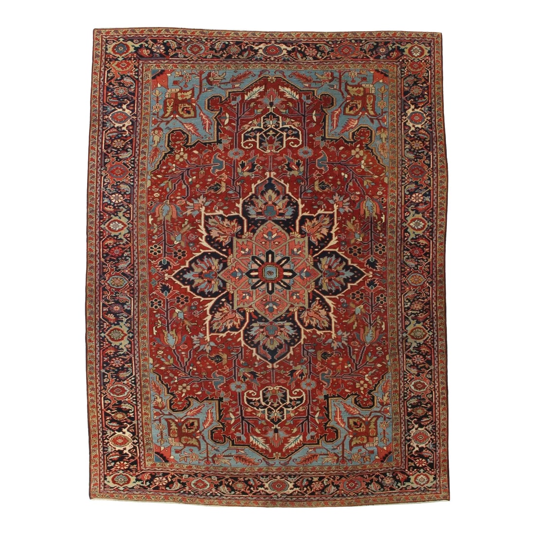 Antique Persian Heriz/Serapi Rug 8'6" X 11'2": Antique hand-knotted Persian Heriz/Serapi wool rug with a red field and bold geometric medallion, surrounded by angular floral and tribal motifs, framed by a navy border. Woven in Heriz, northwest Ira