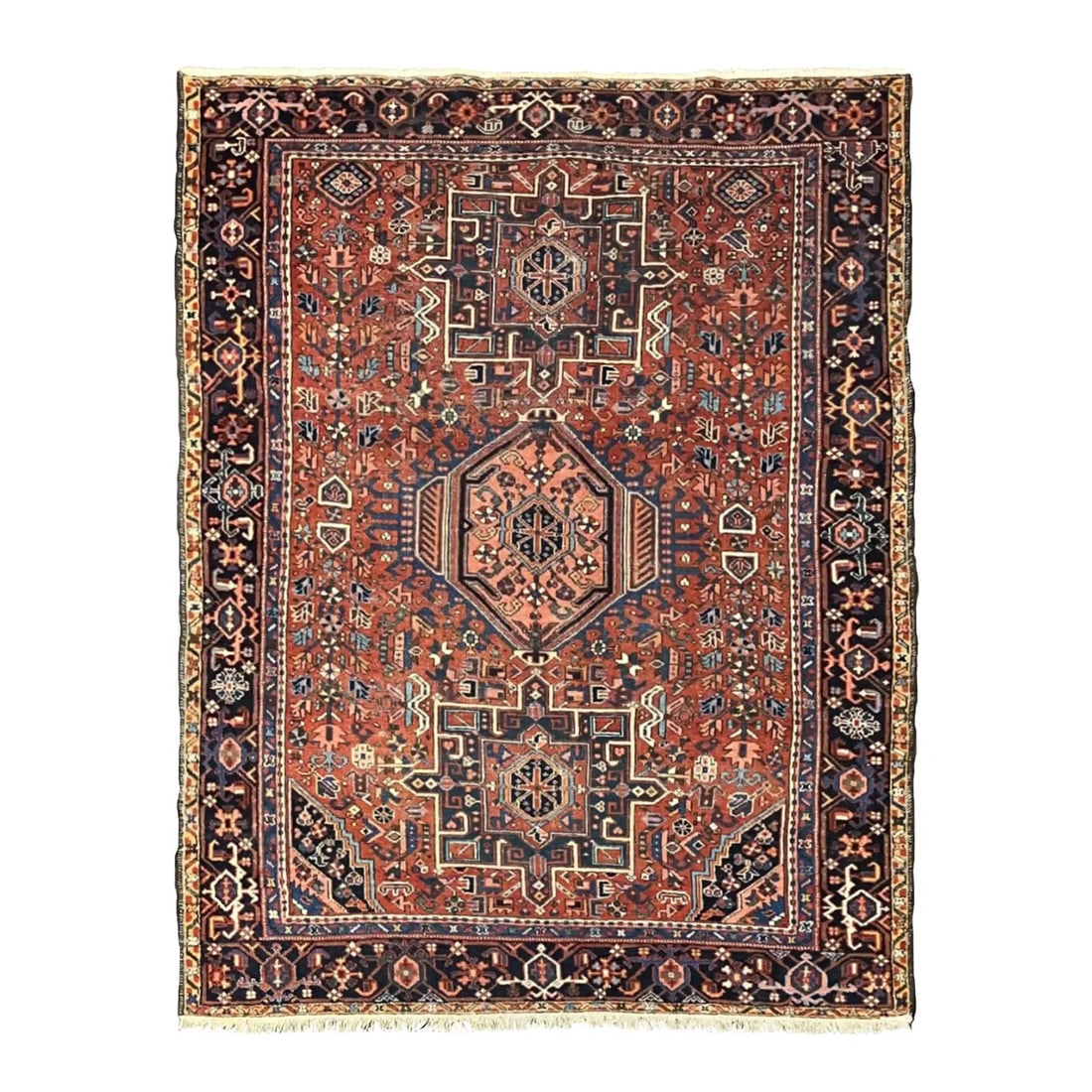 Vintage Persian Heriz Garadjeh Rug 4'8" X 6'0": Hand-knotted Persian Garadjeh Heriz wool rug with a rust-red field and bold geometric medallion design in navy and ivory. The composition features angular tribal and stylized floral motifs, framed by 