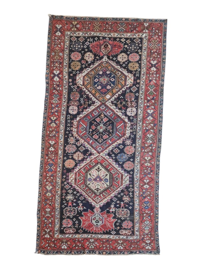 Antique Caucasian Shirvan Kazak Rug 3'11" x 8'4": Antique Caucasian Shirvan Kazak rug featuring an elongated central field with a sequence of geometric medallions and angular motifs, surrounded by patterned borders. Woven in deep navy, red, ivory, ru