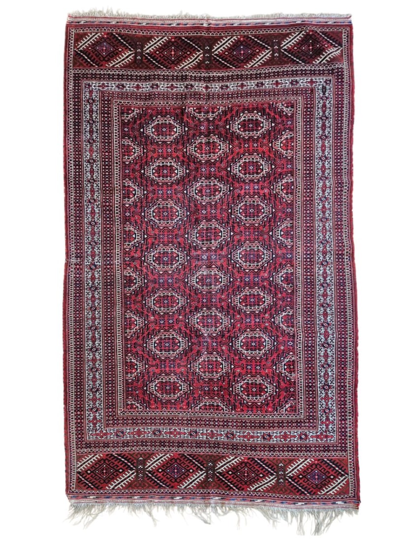 Antique Afghan Turkmen Saroky Rug 5'1" x 8'10": Antique Afghan Turkmen Saroky rug featuring a field with repeating traditional geometric motifs, surrounded by detailed patterned borders. Woven in deep red, navy blue, ivory, rust, and brown tones, w