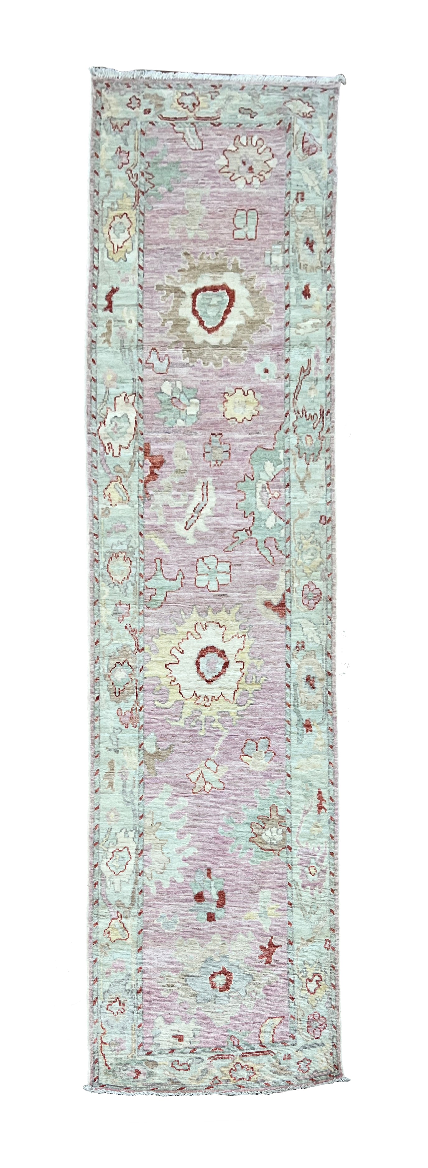 Turkish Oushak Pink Wool Runner 2'9" x 11'8": Turkish Oushak pink runner, hand knotted in Afghanistan from 100% wool. Measuring 2'9" x 11'8", the rug features a soft pink field decorated with large stylized floral and botanical motifs. The design