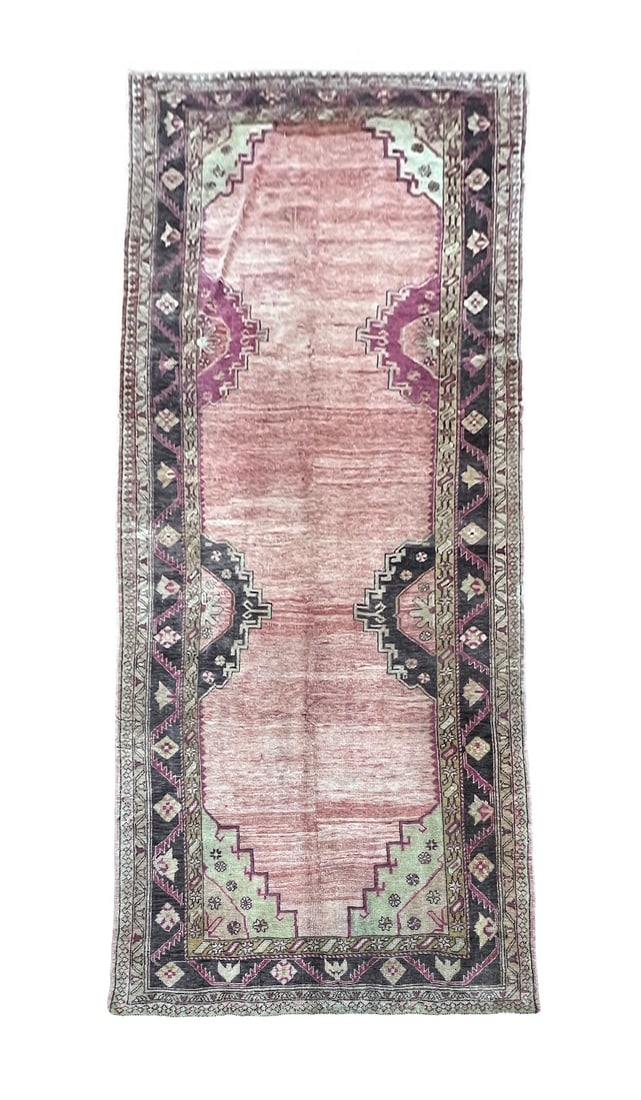 Vintage Turkmen Wool Rug 5'5" x 11': Vintage Turkmen rug, hand knotted in Turkey from 100% wool. Measuring 5'5" x 11', the rug features a traditional tribal-inspired design with an elongated open field in soft muted rose and dusty pink t