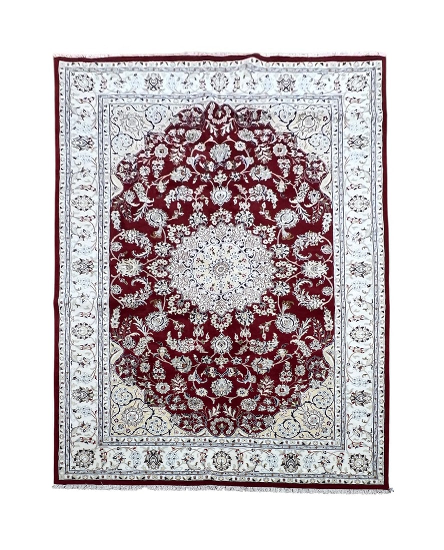 Persian Nain Wool Rug 6'1" x 9'2": Persian Nain rug, hand knotted in India from 100% wool. Measuring 6'1" x 9'2", the rug features an elegant central medallion surrounded by intricate floral and botanical motifs. The rich burgundy red 