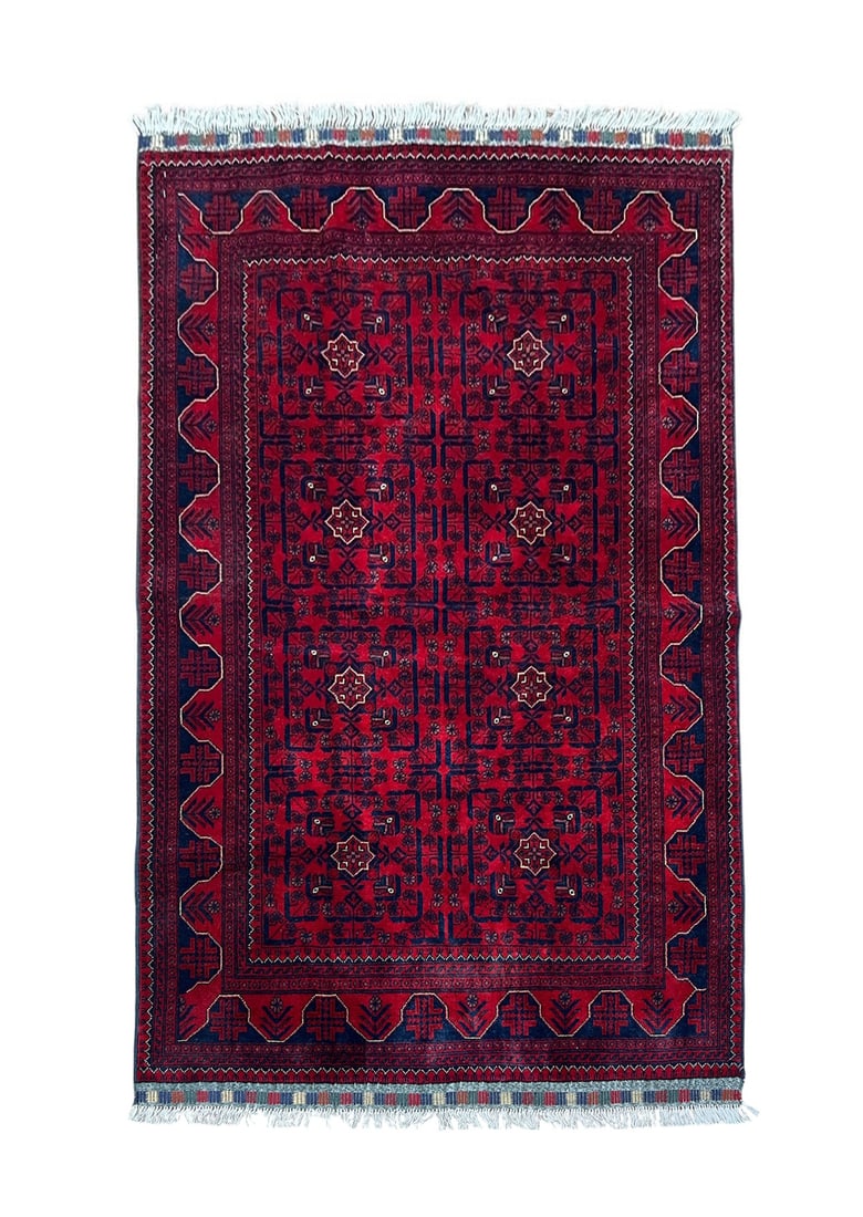 Afghan Turkmen Wool Rug 4'3" x 6'6": Afghan Turkmen rug, hand knotted in Afghanistan from 100% wool. Measuring 4'3" x 6'6", this rug features a rich deep red field decorated with traditional repeating geometric medallions and tribal moti