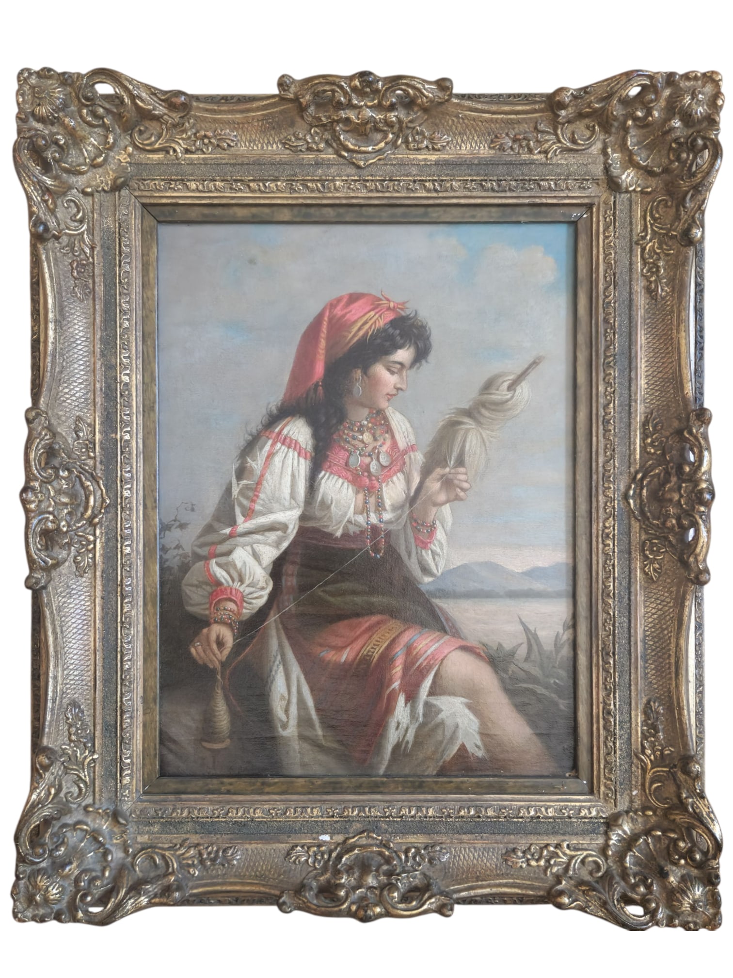 G. Schreiber - The Spinner, Oil on Canvas: European genre painting depicting a young woman in traditional dress spinning wool by hand, set against a distant mountainous landscape. Signed "G. Schreiber" lower left. Oil on canvas, presented in a