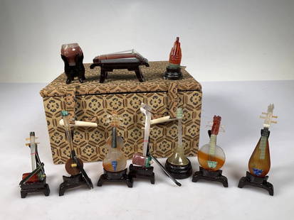 Miniature Jade Carved Traditional Instruments Set: This set features intricately carved miniature versions of traditional Chinese musical instruments, crafted from jade, agate, and other semi-precious stones. Each piece represents instruments such as