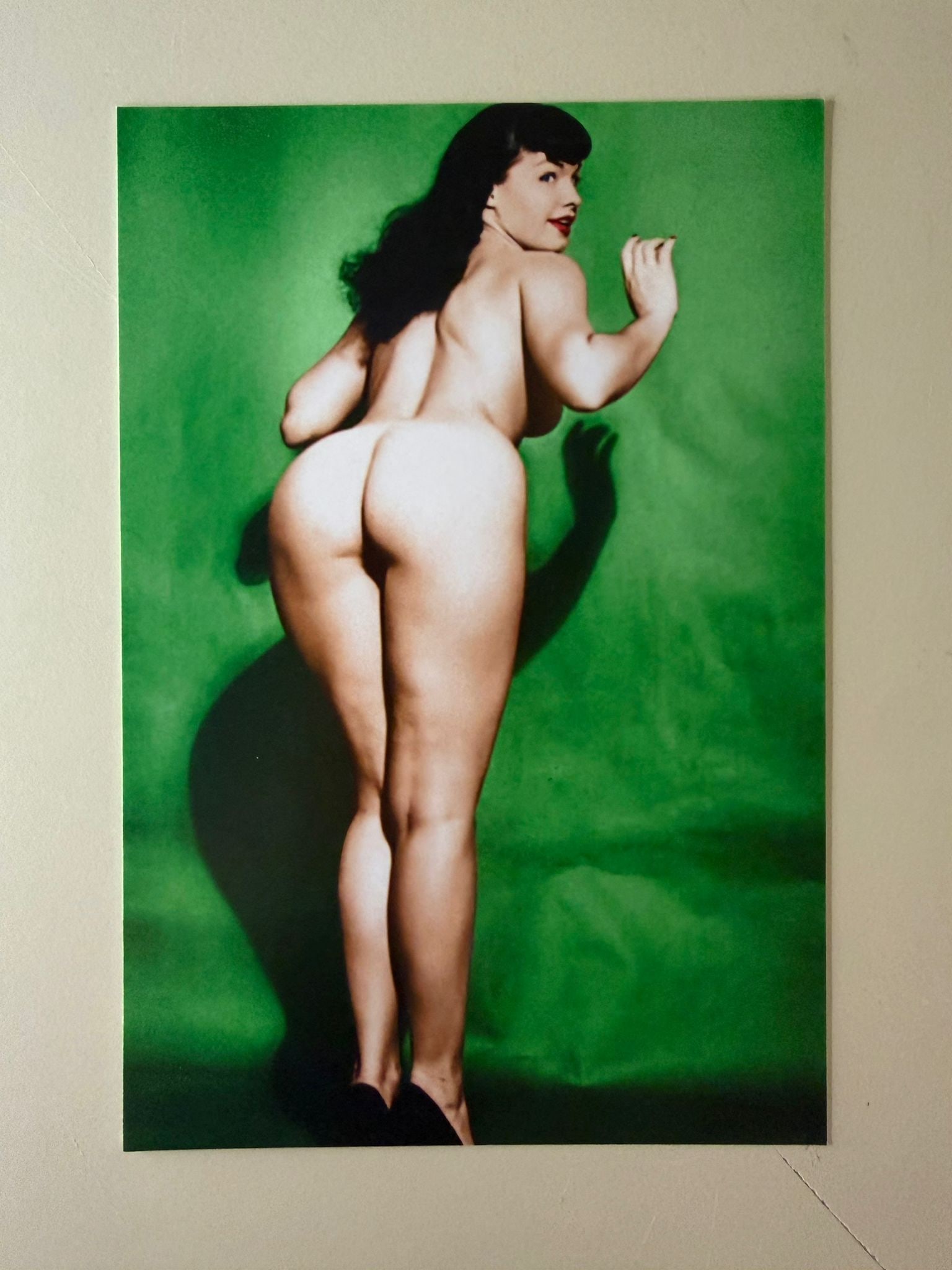 Signed Bunny Yeager Photograph of Bettie Page: Original color photographic print depicting the legendary American pin-up icon Bettie Page, photographed by the renowned photographer Bunny Yeager. The image captures one of Page's most iconic glamour
