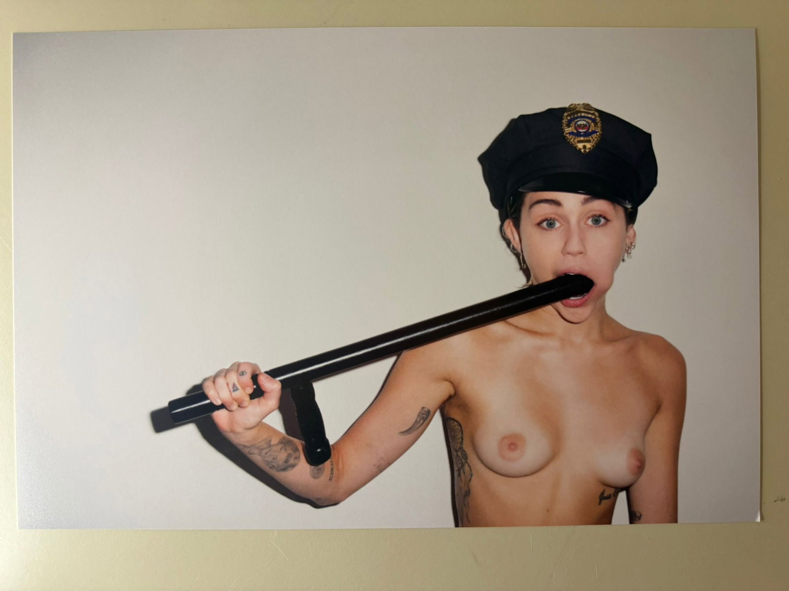 Terry Richardson – Miley Cyrus, Signed Photographic Print - 32x22 cm: A signed photographic print by the influential American photographer Terry Richardson, depicting Miley Cyrus in one of his unmistakable minimalist portrait compositions.Photographed against a plain wh