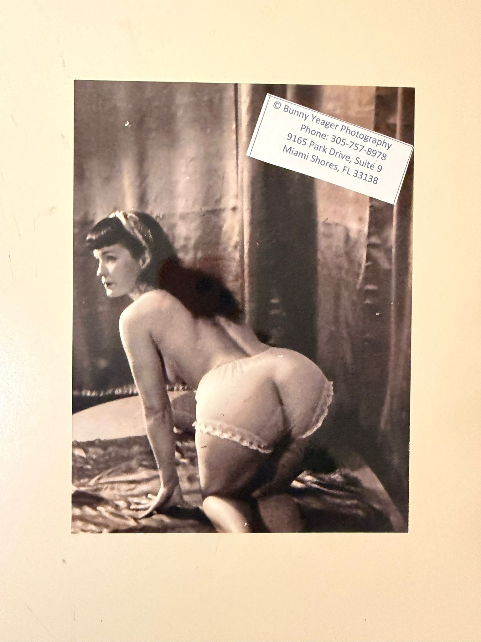 Bunny Yeager – Bettie Page in White Panties | Signed Photograph: An original signed photographic print by the celebrated American glamour photographer Bunny Yeager, depicting the legendary pin-up model Bettie Page, one of the most iconic figures of 1950s photograph