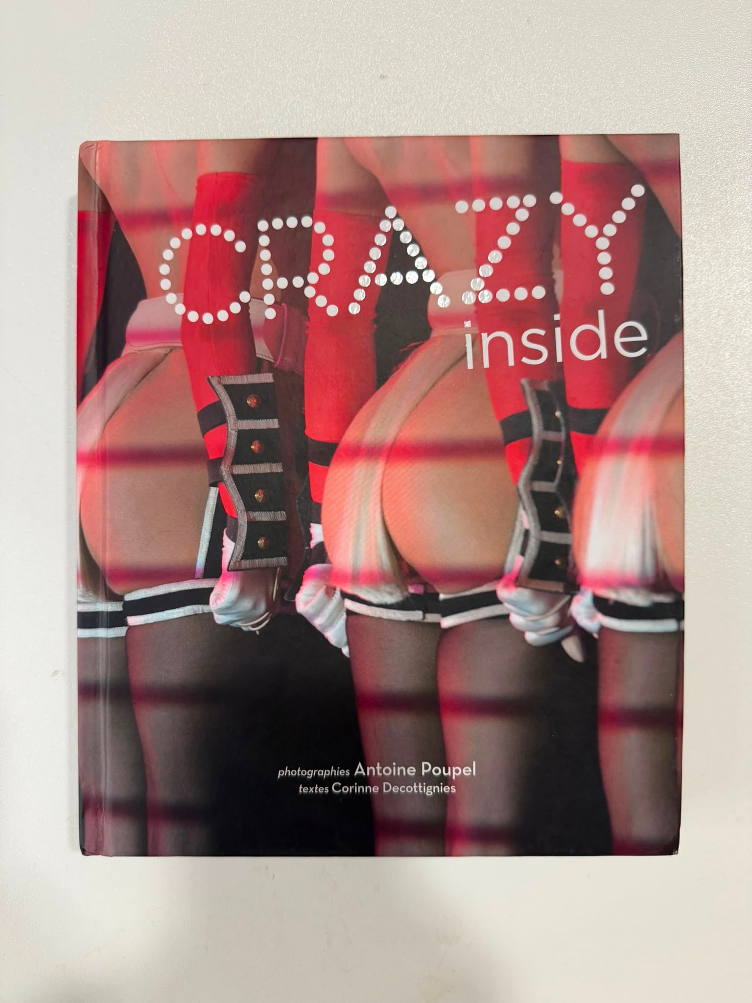 Antoine Poupel – “Crazy Inside” (2010) | Hardcover Photobook Signed with Dedication by the: Antoine Poupel“Crazy Inside”Photographs by Antoine Poupel | Text by Corinne DecottigniesFormat: Hardcover PhotobookInscriptions: Hand-signed by Antoine Poupel in silver paint pen on the bright