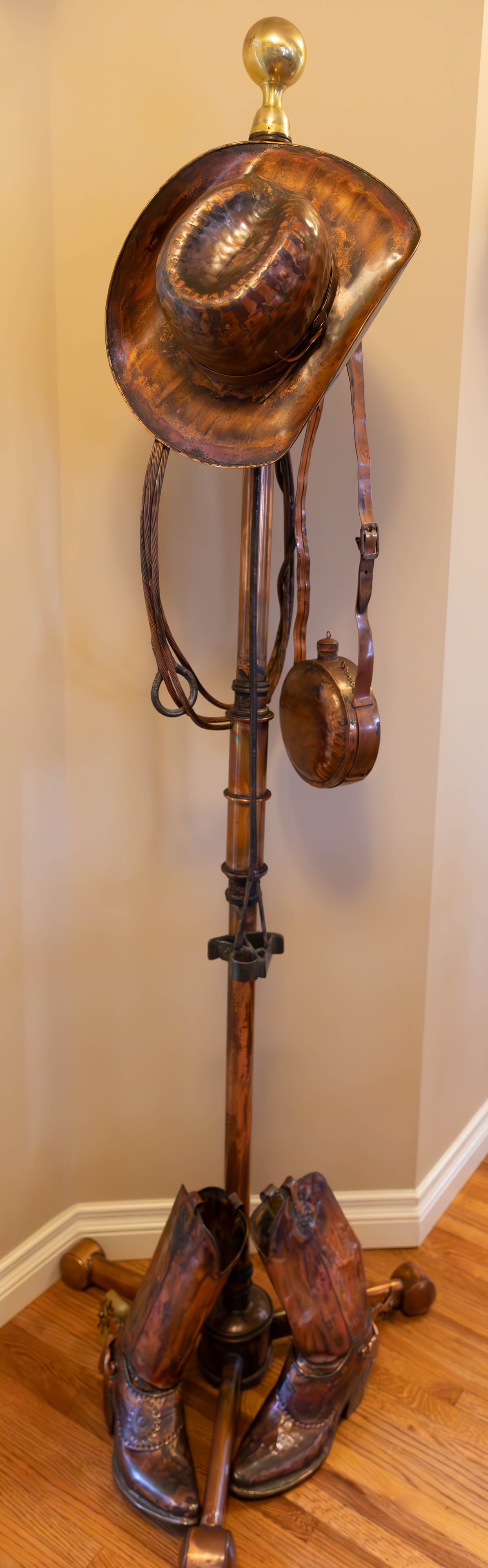 Metal and Copper Western Coat Rack: Metal and Copper Western Coat Rack, Metal and Copper detailing (Includes metal cowboy boots, lasso, water bag). Sturdy, shiny and polished. No shipping on this item. Pick up (in Calgary, Alberta) only