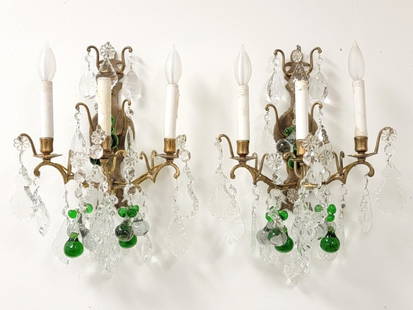 PAIR ANTIQUE BRASS THREE ARM WALL SCONCES: Pair of antique cast brass three arm wall sconces, later electrified. Outfitted with clear and emerald green colored crystals and drops. Each sconce measures a total of 13.75" tall x 11.75" wide and 6