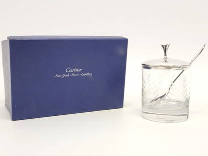 CARTIER STERLING SILVER & GLASS CONDIMENT JAR: Cartier sterling silver and glass lidded condiment jar with original Cartier spoon. Measures a total of 4.5" tall x 3" diameter. Glass is unmarked, both the spoon and lid are marked Cartier sterling.